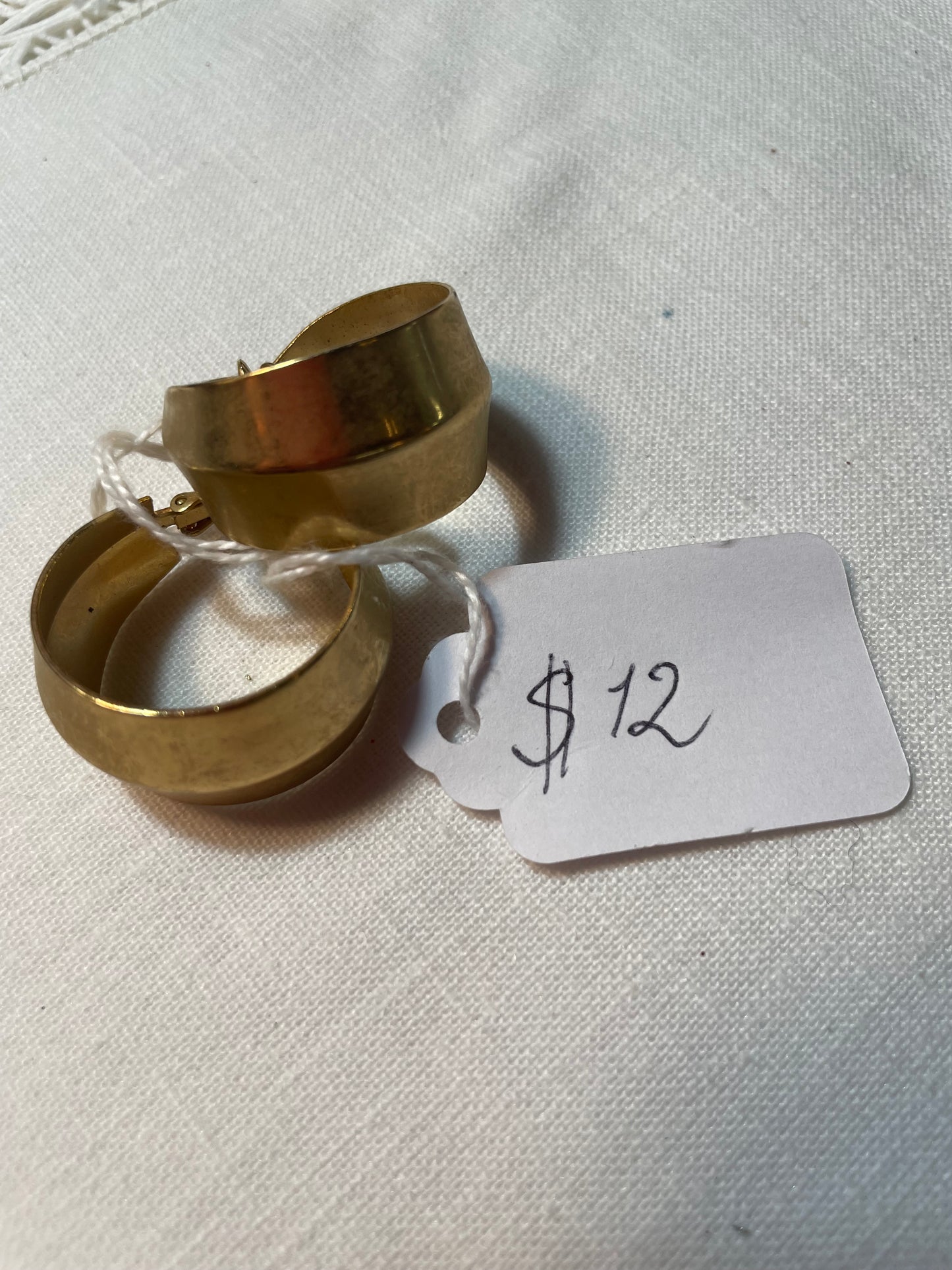 A pair of golden hoop earrings, clip on