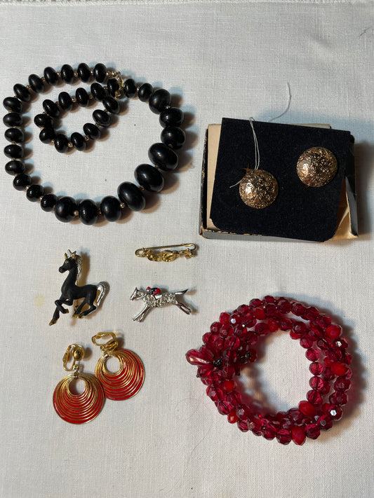 A lot of vintage jewelry with equestrian brooches